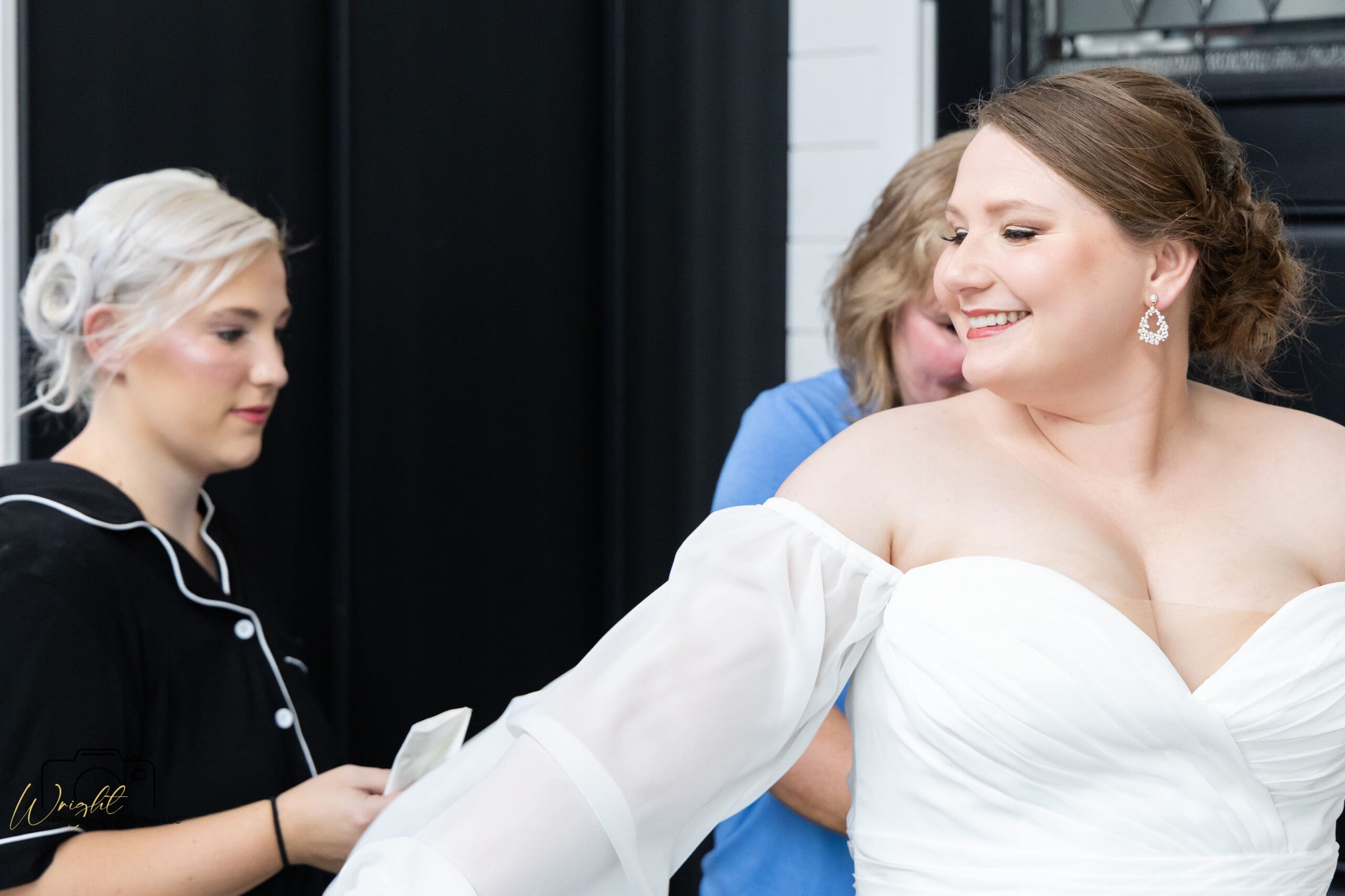 Emily being laced into her wedding gown
