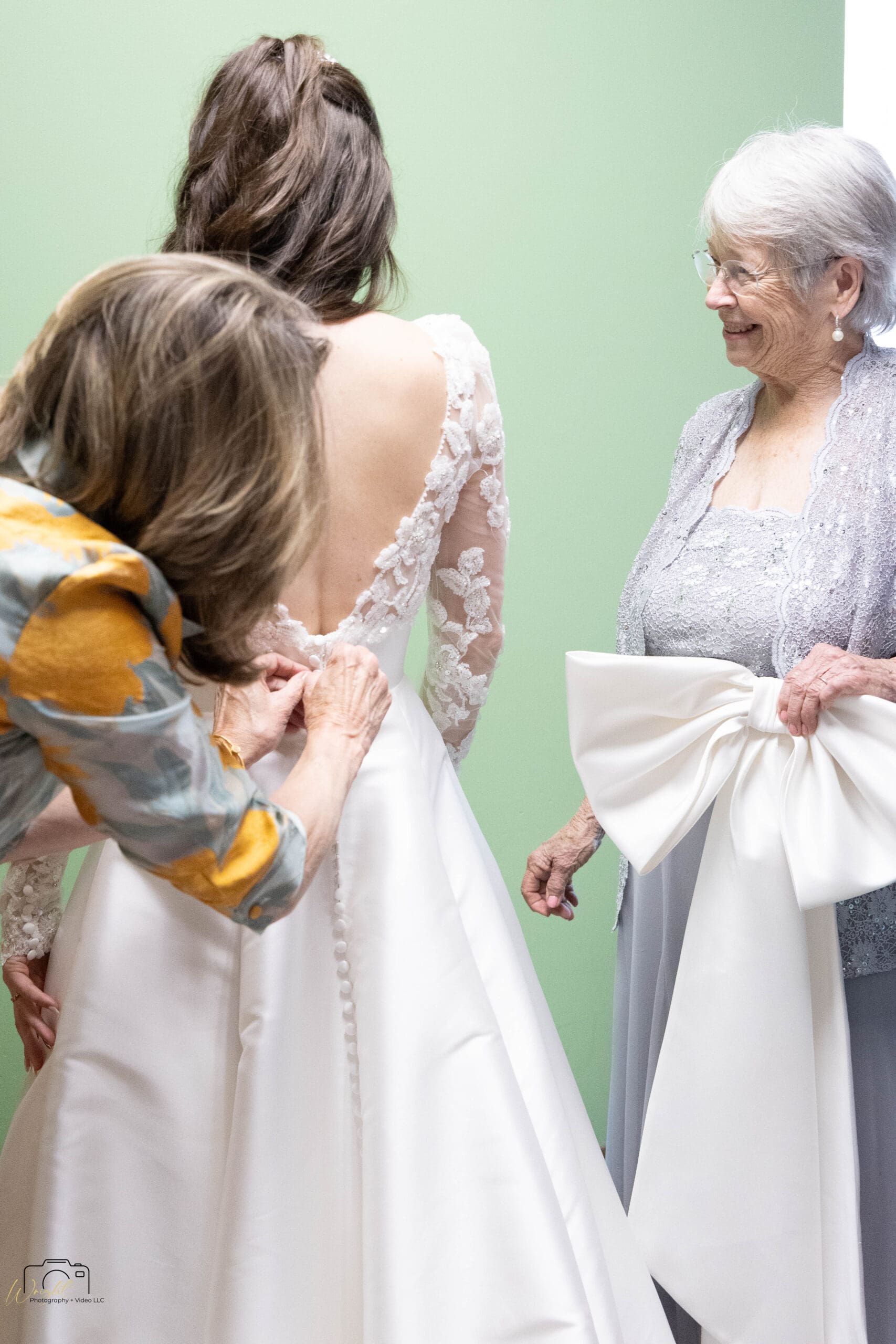 Elizabeth being buttoned into her gown with close family members present