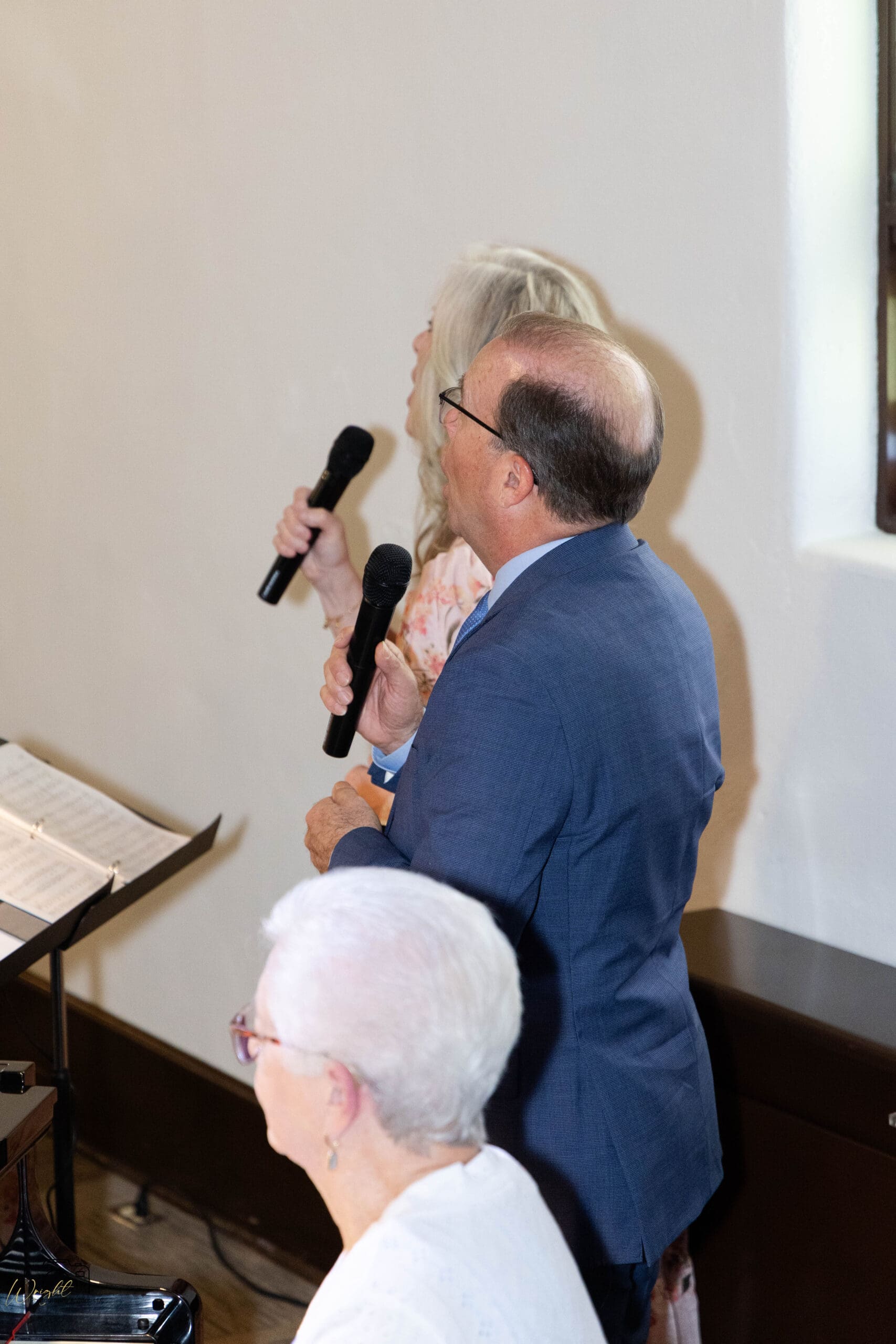 Spencer and Melissa singing "I Speak Jesus" during the ceremony