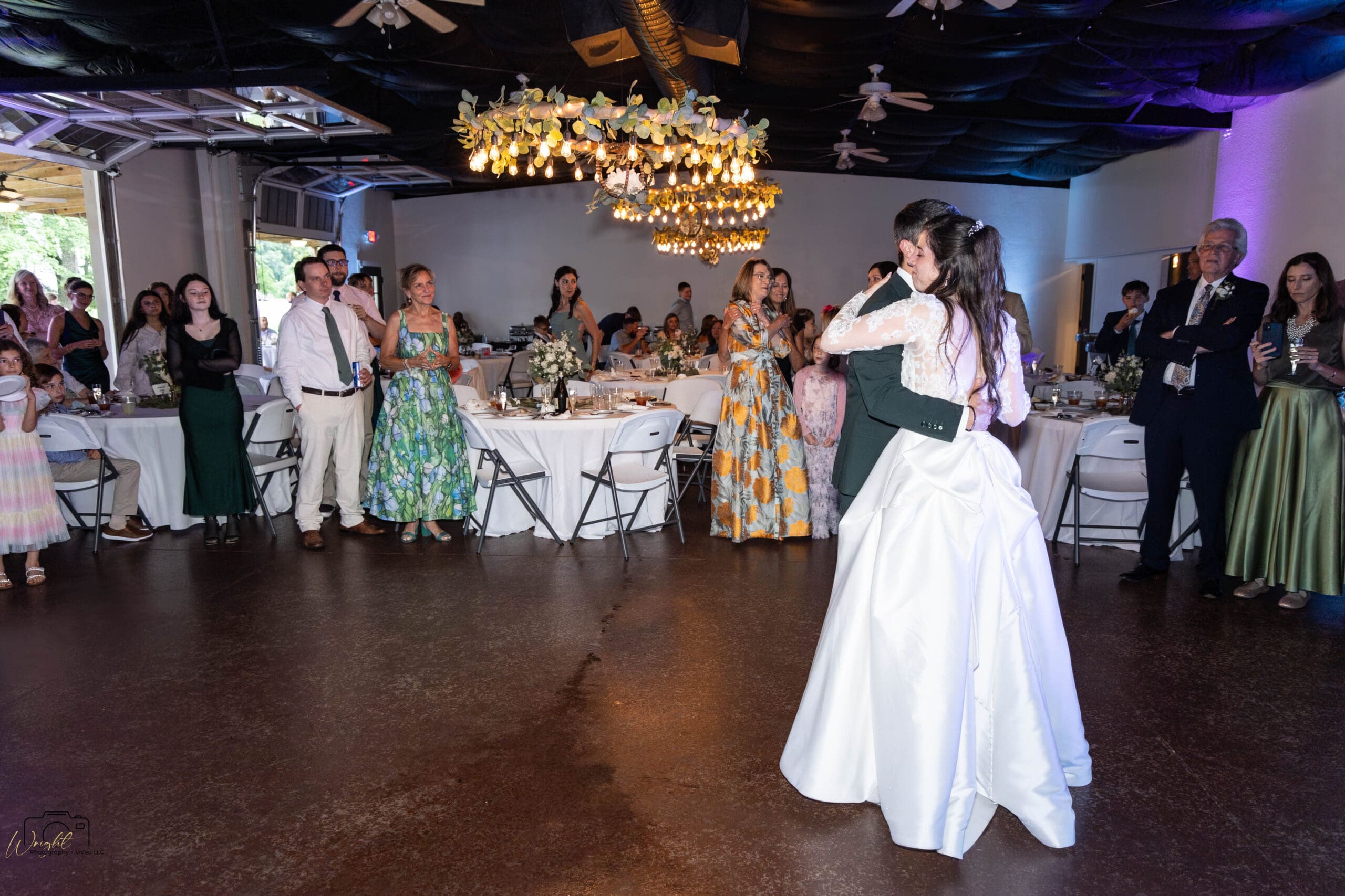 Ryan and Elizabeth dancing together, surrounded by guests