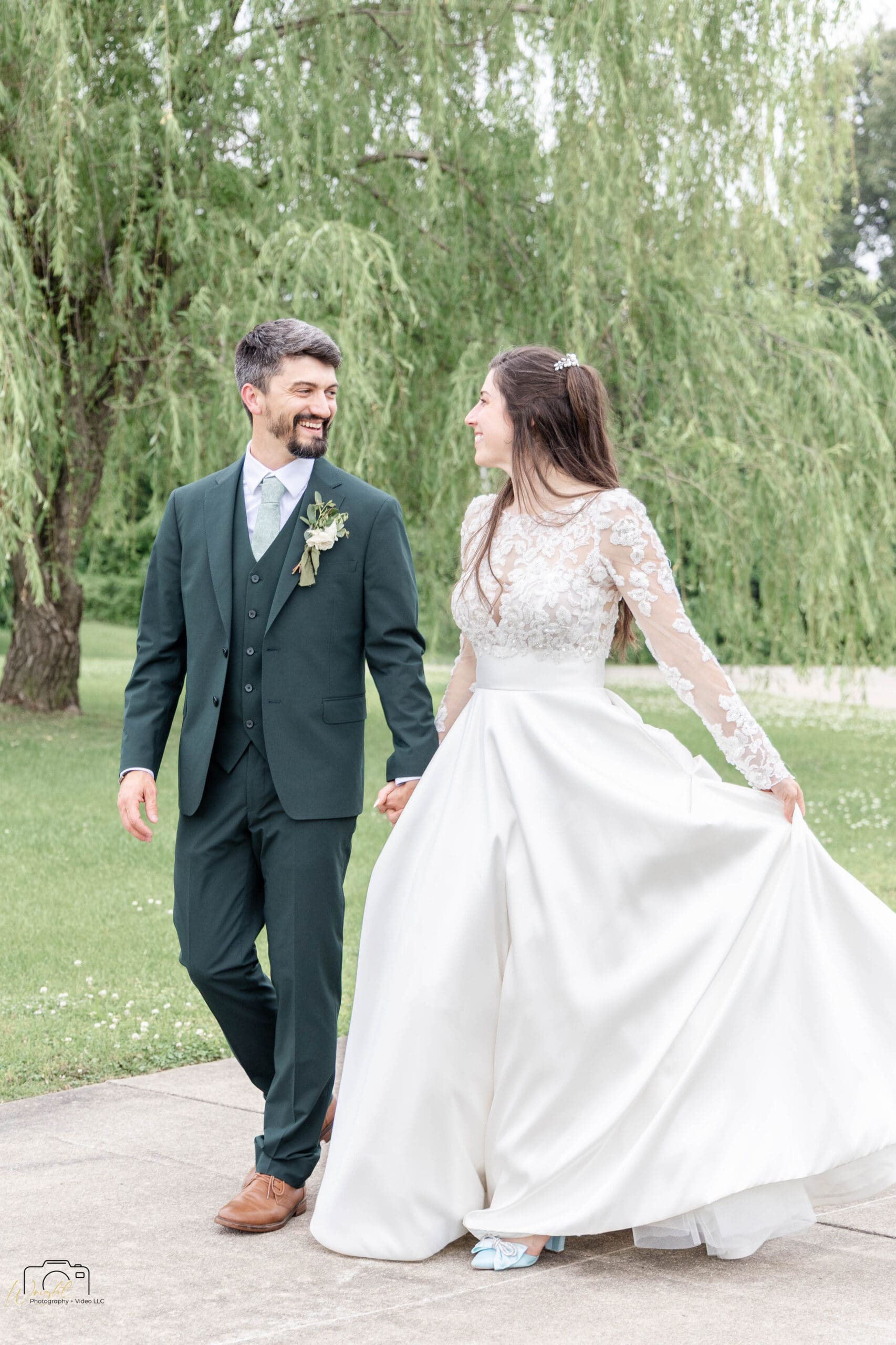 Ryan and Elizabeth walking the paved path by the willow tree