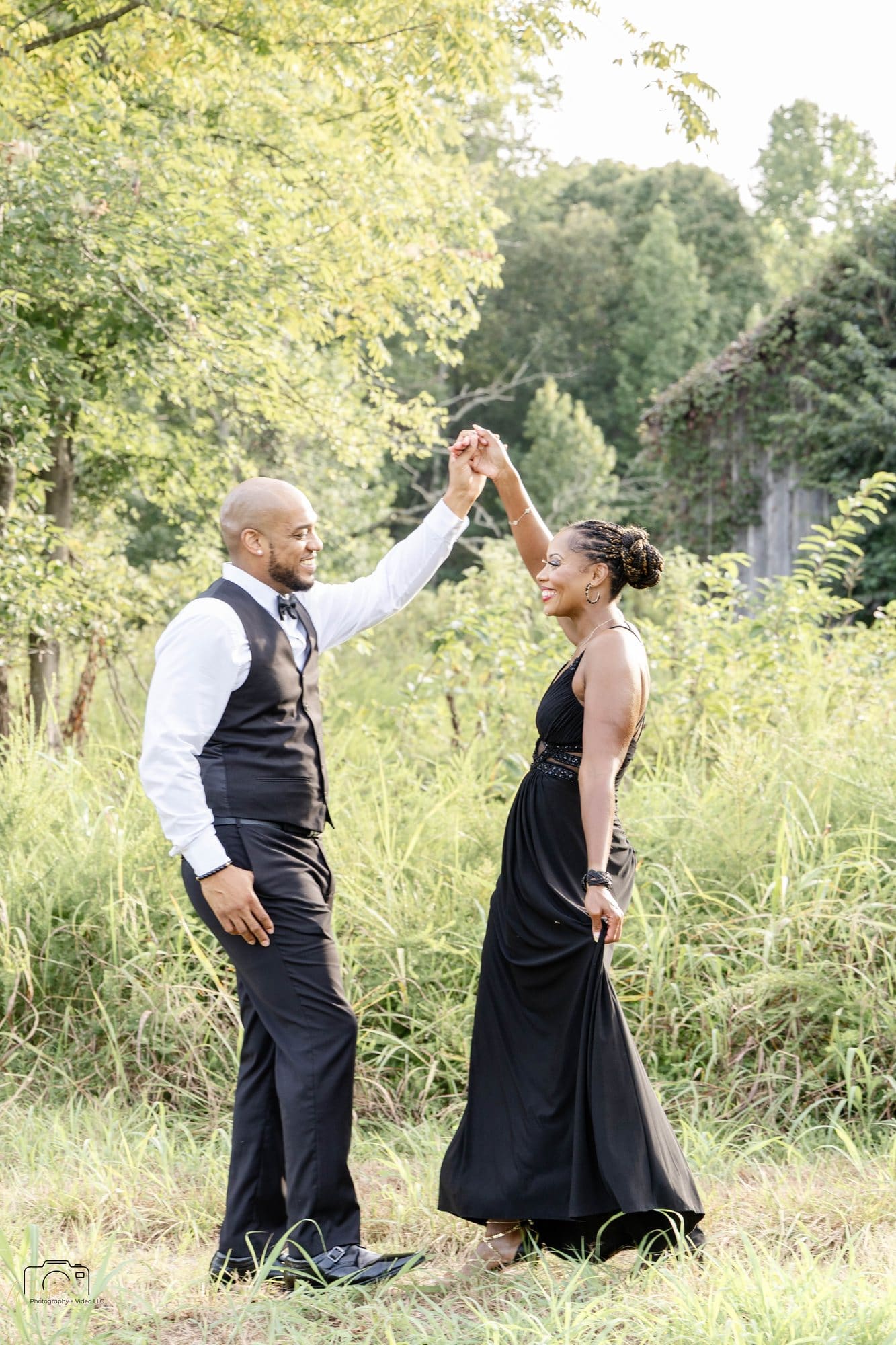 David twirling Nikeesha in her black gown in tall grass at Empire Point, Land Between the Lakes, Kentucky