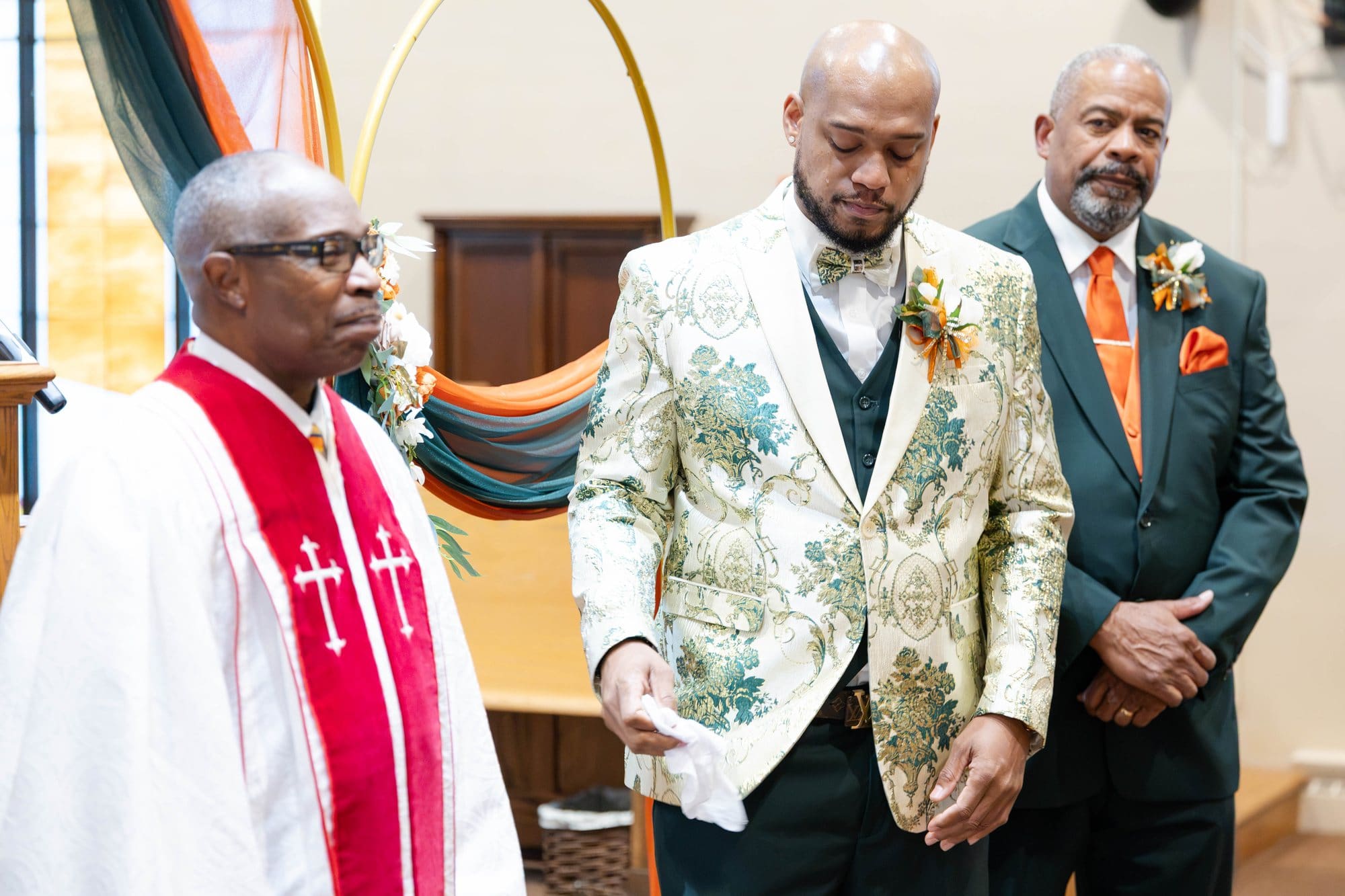 David entering the sanctuary in his brocade jacket beside Rev. Dr. Cole Sr. in a white robe and red stole and his father