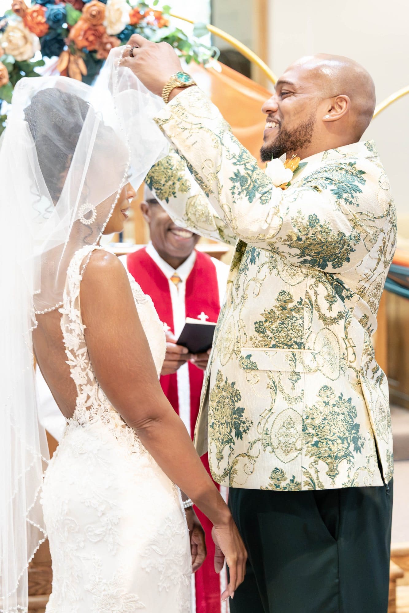 David smiling as he lifts Nikeesha's veil at the altar