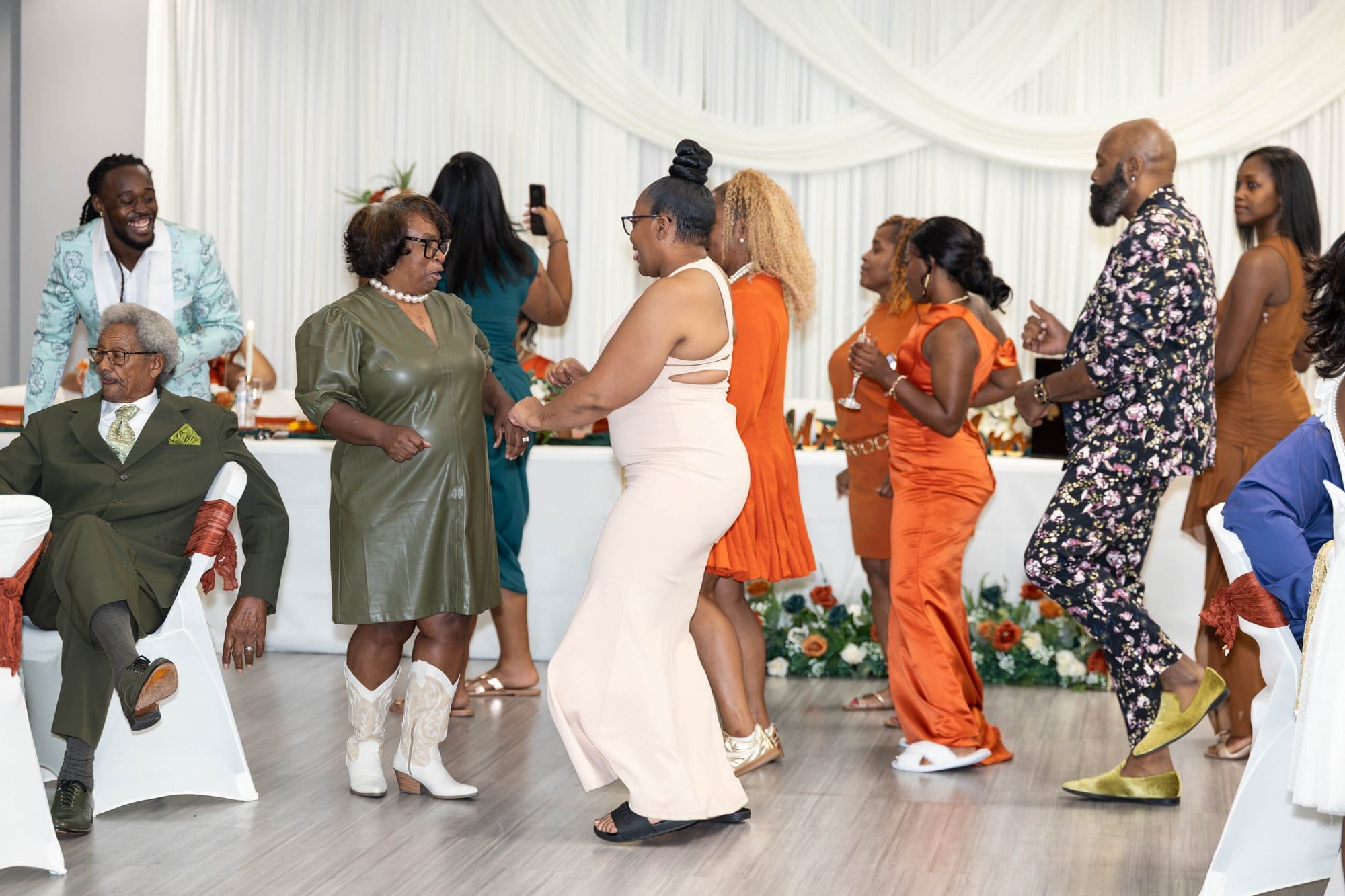 Guests dancing and laughing on the reception dance floor